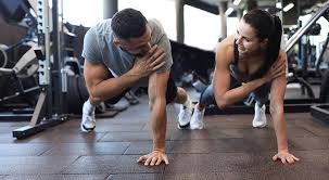 Image of man and woman doing Cardio Hampshire to tone their arms. 